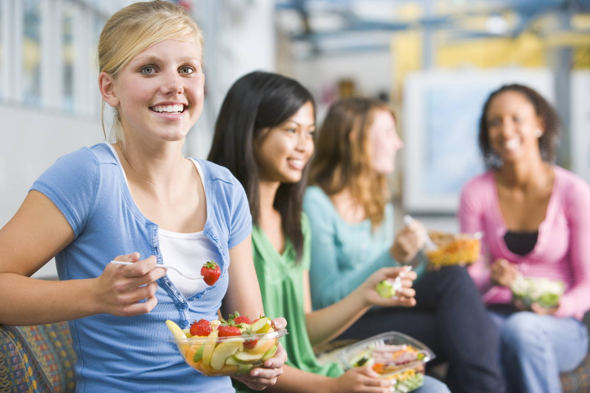 teenage girls enjoying healthy lunches together